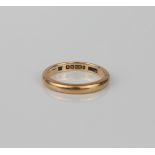 A 9ct yellow gold wedding band - hallmarked Birmingham 1947, size L.