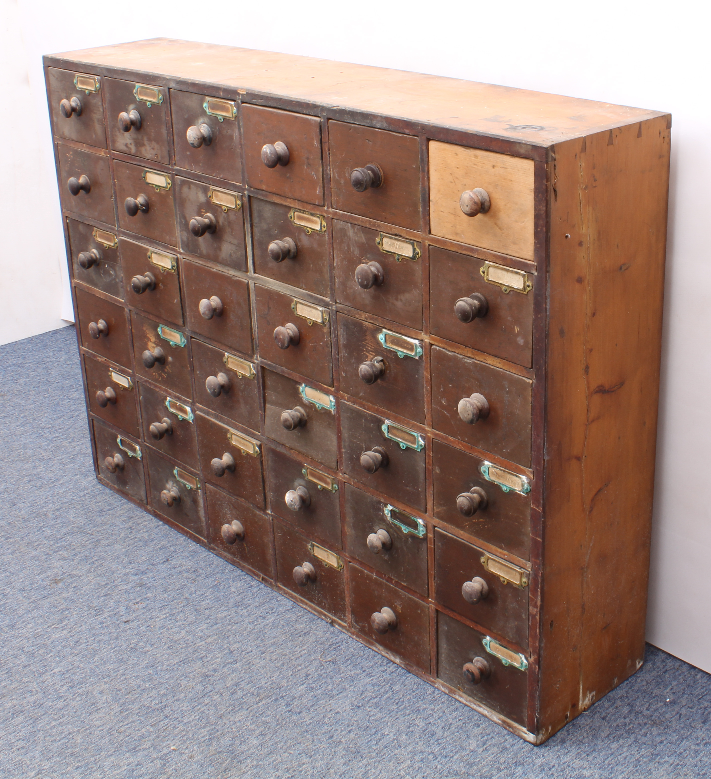 An early 20th century pine and beech wood 30-drawer pharmacy or shopkeeper's cabinet - the