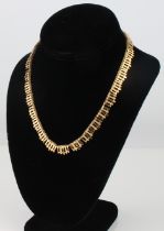 A vintage 9ct gold fringe necklace - stamped '9 375', with bark effect and polished gold gate links,