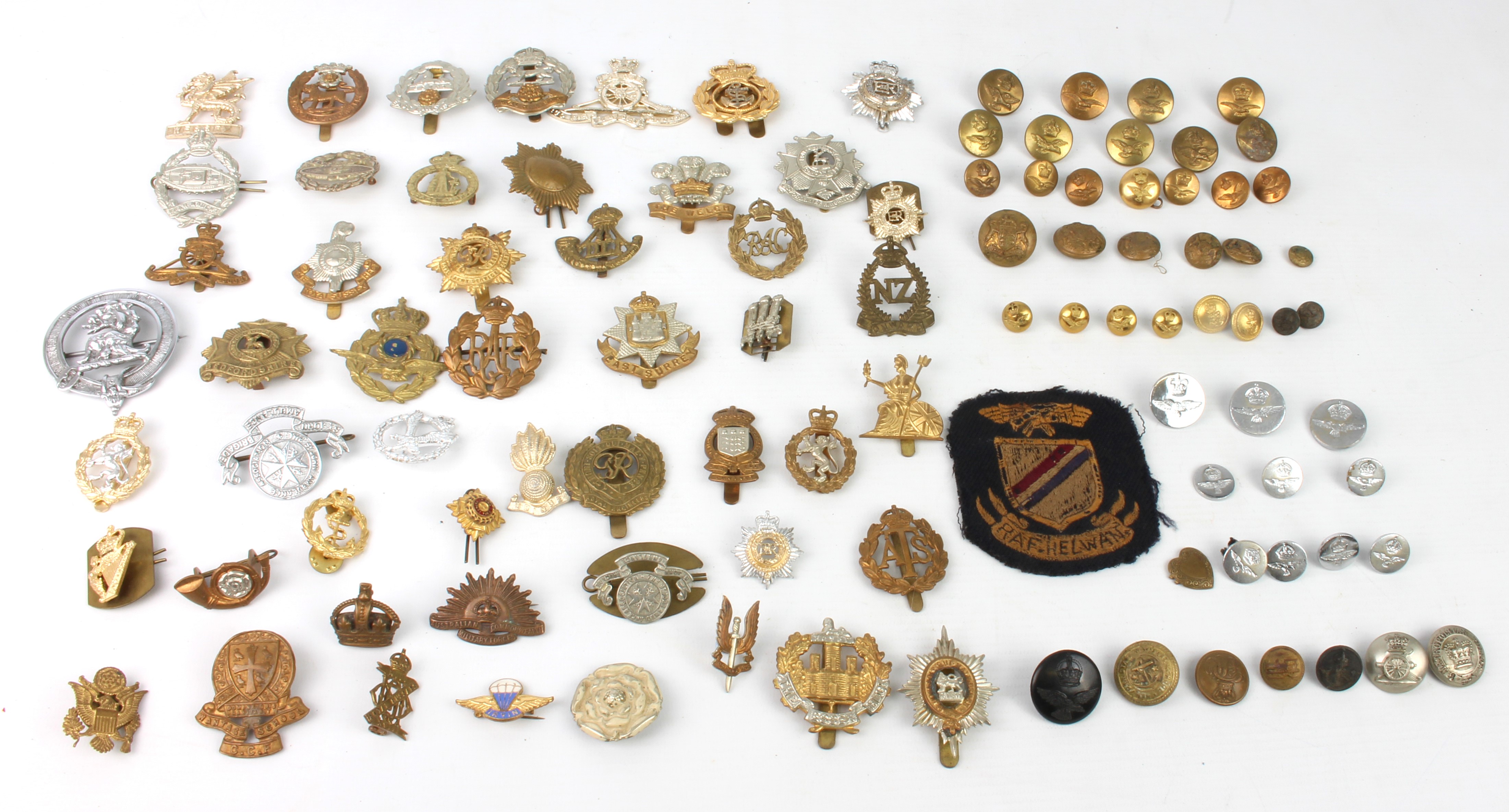 A good quantity of cap badges and tunic buttons