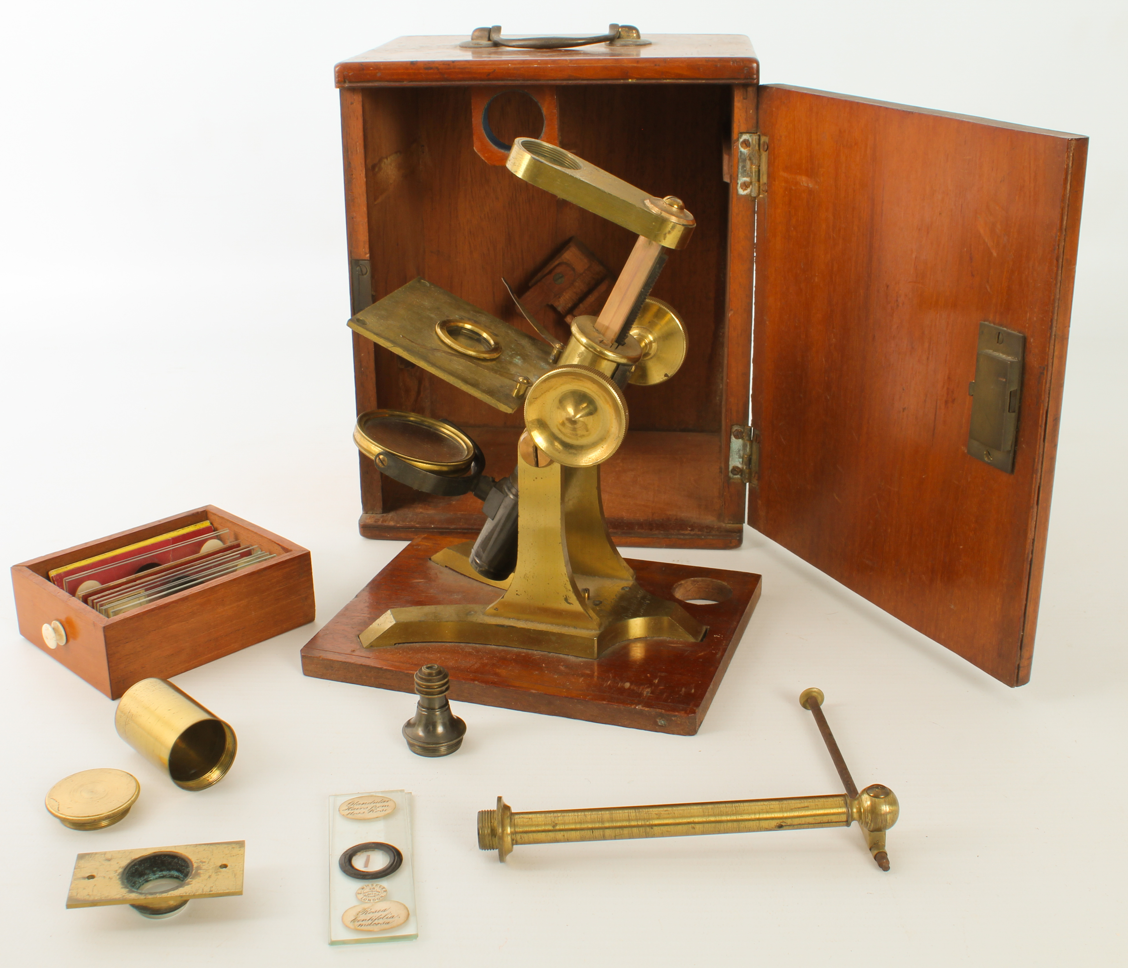 A Victorian lacquered brass microscope by W. Gray of London - lacks main tube, with rack and