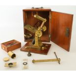 A Victorian lacquered brass microscope by W. Gray of London - lacks main tube, with rack and