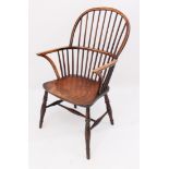 An early 19th century yew wood, beech and elm hoop back Windsor arm chair - the yew wood hoop back