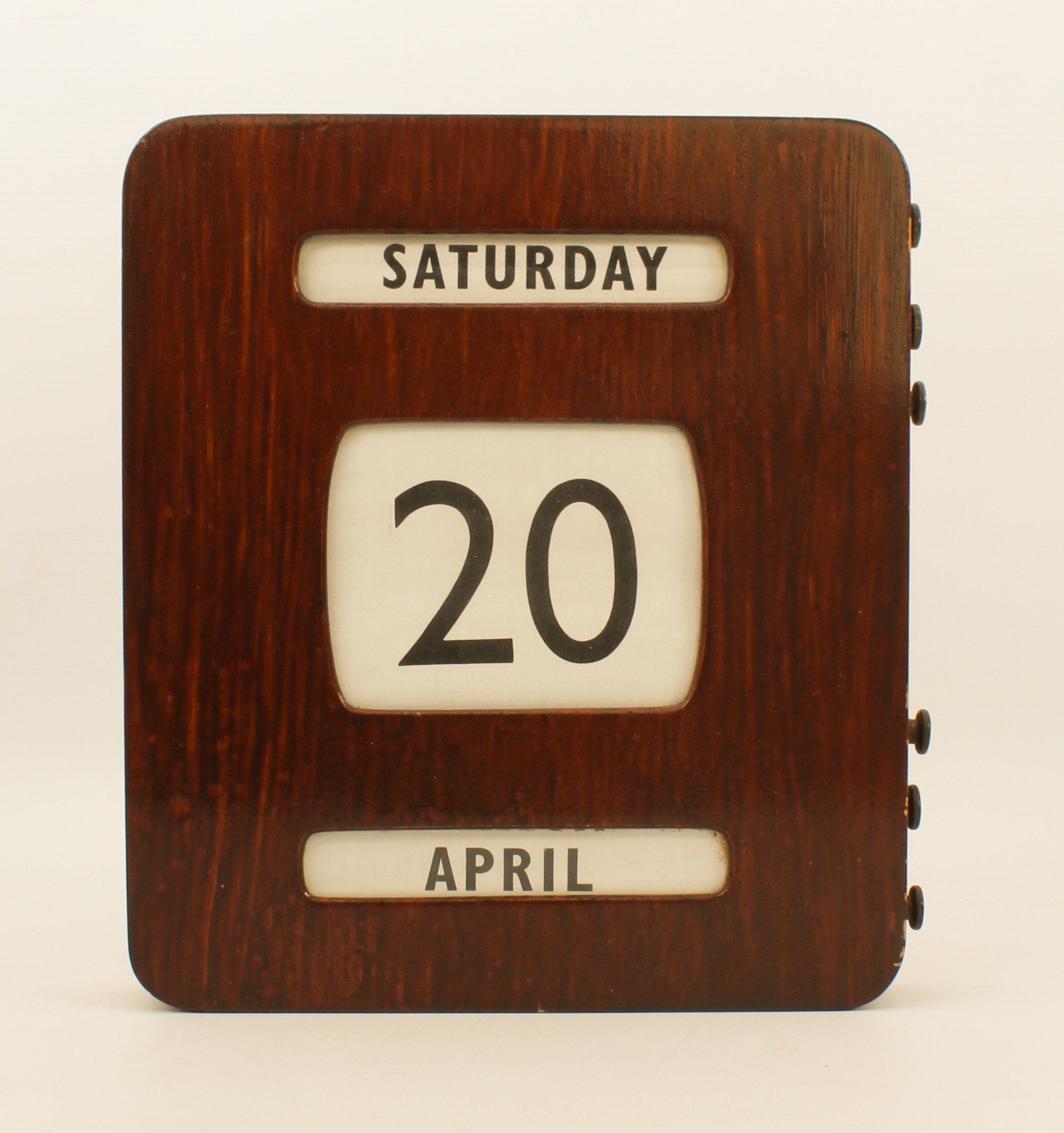 A mid-20th century wall-hanging perpetual calendar - in a stained plywood case with brass button-