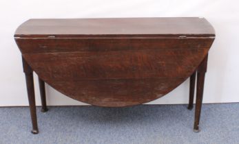 An 18th century joined oak oval gateleg dining table - the two-plank top raised on turned, tapered