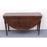 An 18th century joined oak oval gateleg dining table - the two-plank top raised on turned, tapered