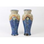 A pair of Royal Doulton stoneware baluster vases - impressed factory marks and incised decorator's