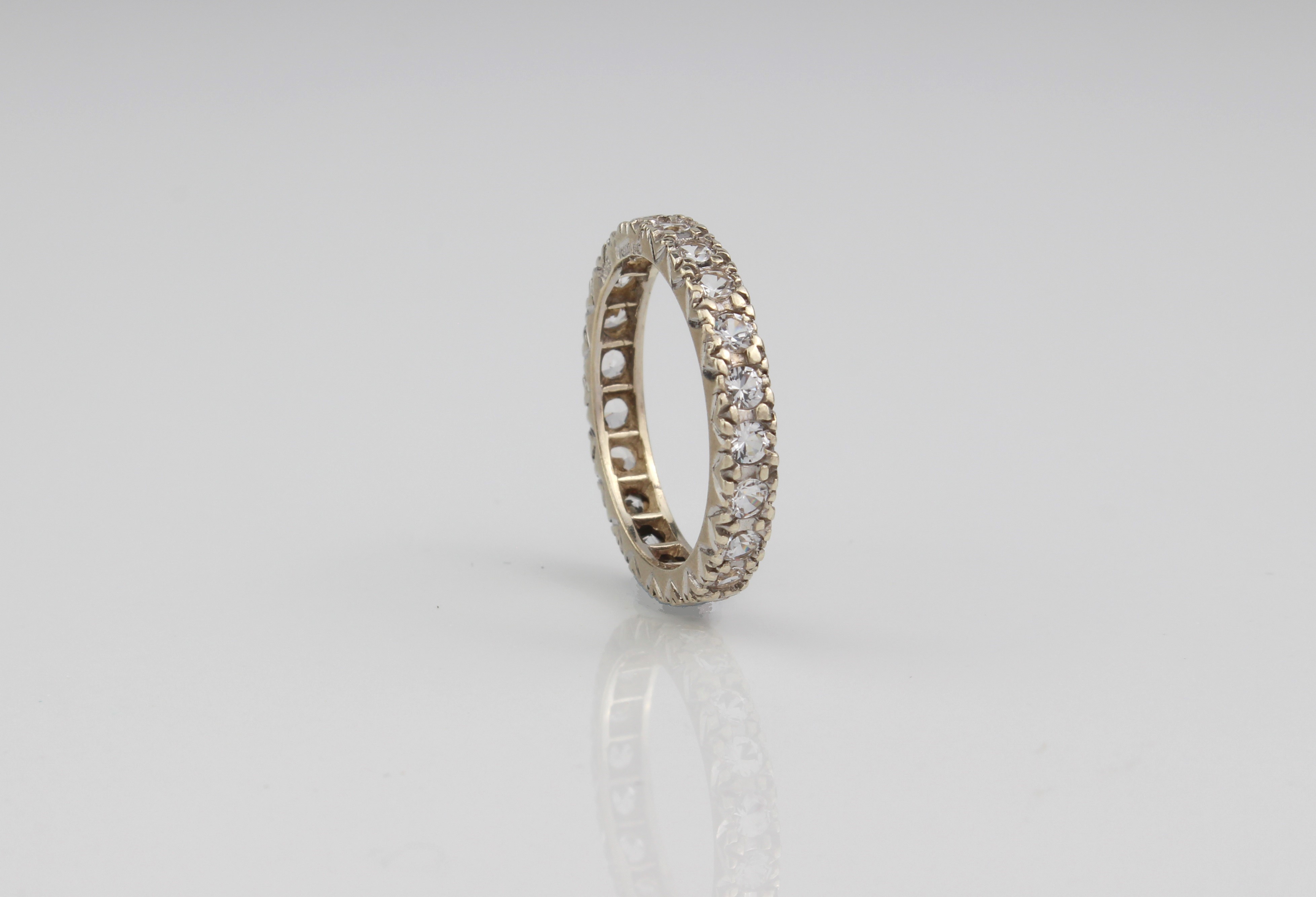 A 9ct gold two-colour sapphire eternity ring.