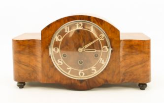 An Art Deco walnut-cased mantel clock - 1940s-50s, the serpentine, broken-arch case with Arabic,