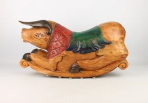 A carved and painted wooden rocking pig - probably Indonesian, late 20th century, the long ears