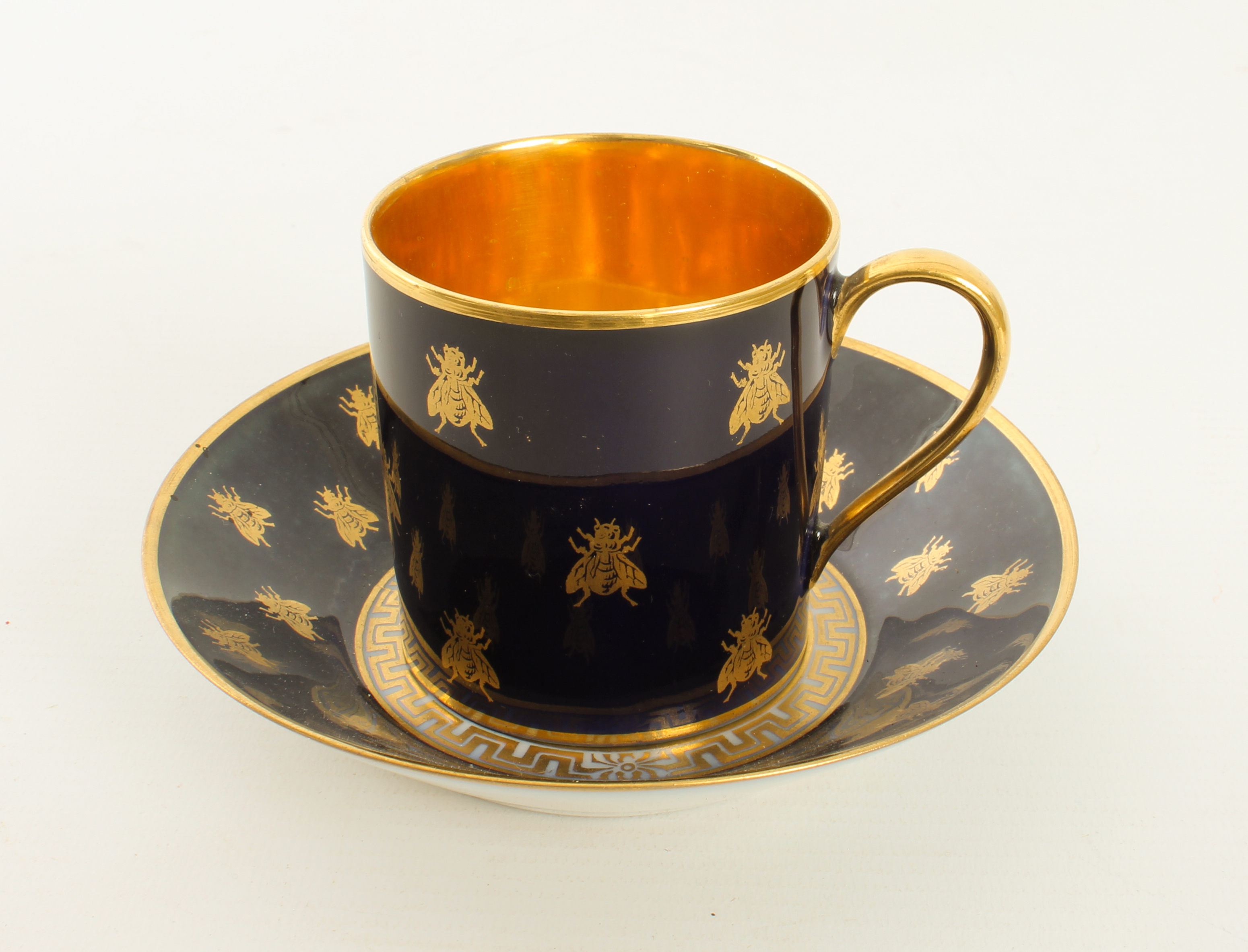 A 19th century Sèvres armorial 'Napoleon' coffee can and saucer - with iron red 'M. Imple de Sèvres'