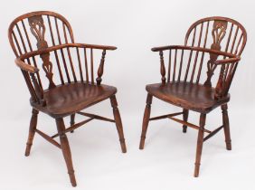 A closely matched pair of early 19th century yew, ash, beech and elm Windsor arm chairs - North