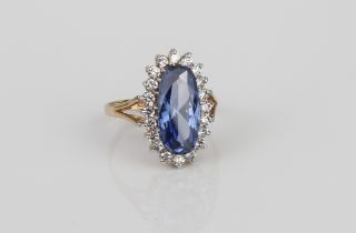 A 9ct yellow gold, synthetic sapphire and CZ cluster ring - size O.