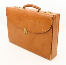 A 1950s tan leather briefcase - gilt-brass fittings and top handle, the locks with key, with