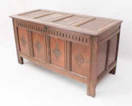 An 18th century joined carved oak coffer - the top on later strap hinges, interior lacking till,