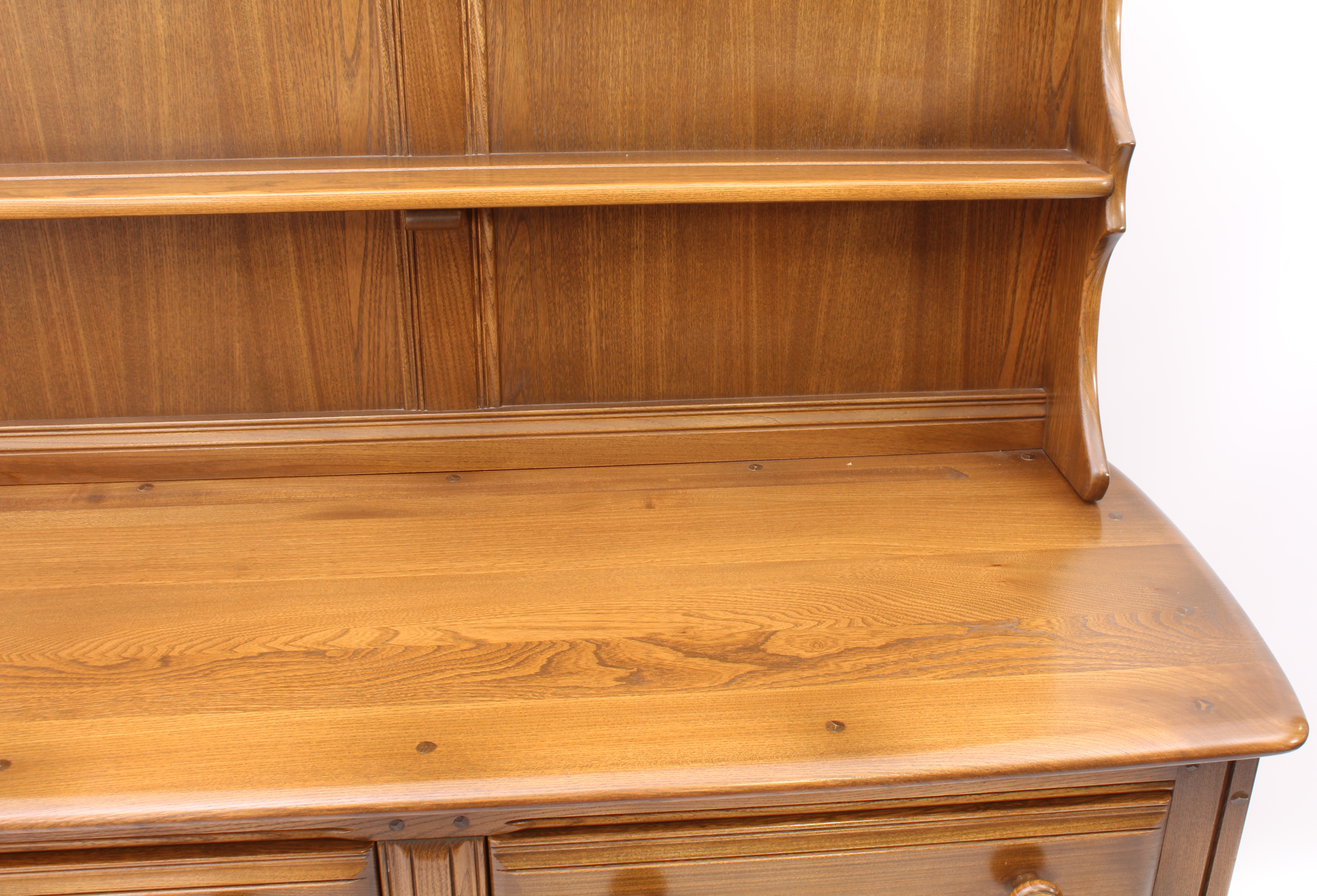 An Ercol Windsor elm dresser - the back with waterfall plate rack, over a base with two drawers (one - Image 5 of 8