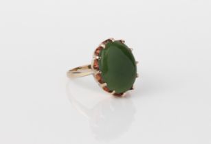 A vintage 9ct yellow gold and jade ring - the 14 x 11mm oval cabochon green jade in a crown claw