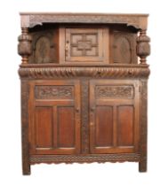 An early 18th century style carved oak court cupboard - 20th century, the foliate S-scroll carved