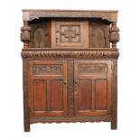 An early 18th century style carved oak court cupboard - 20th century, the foliate S-scroll carved