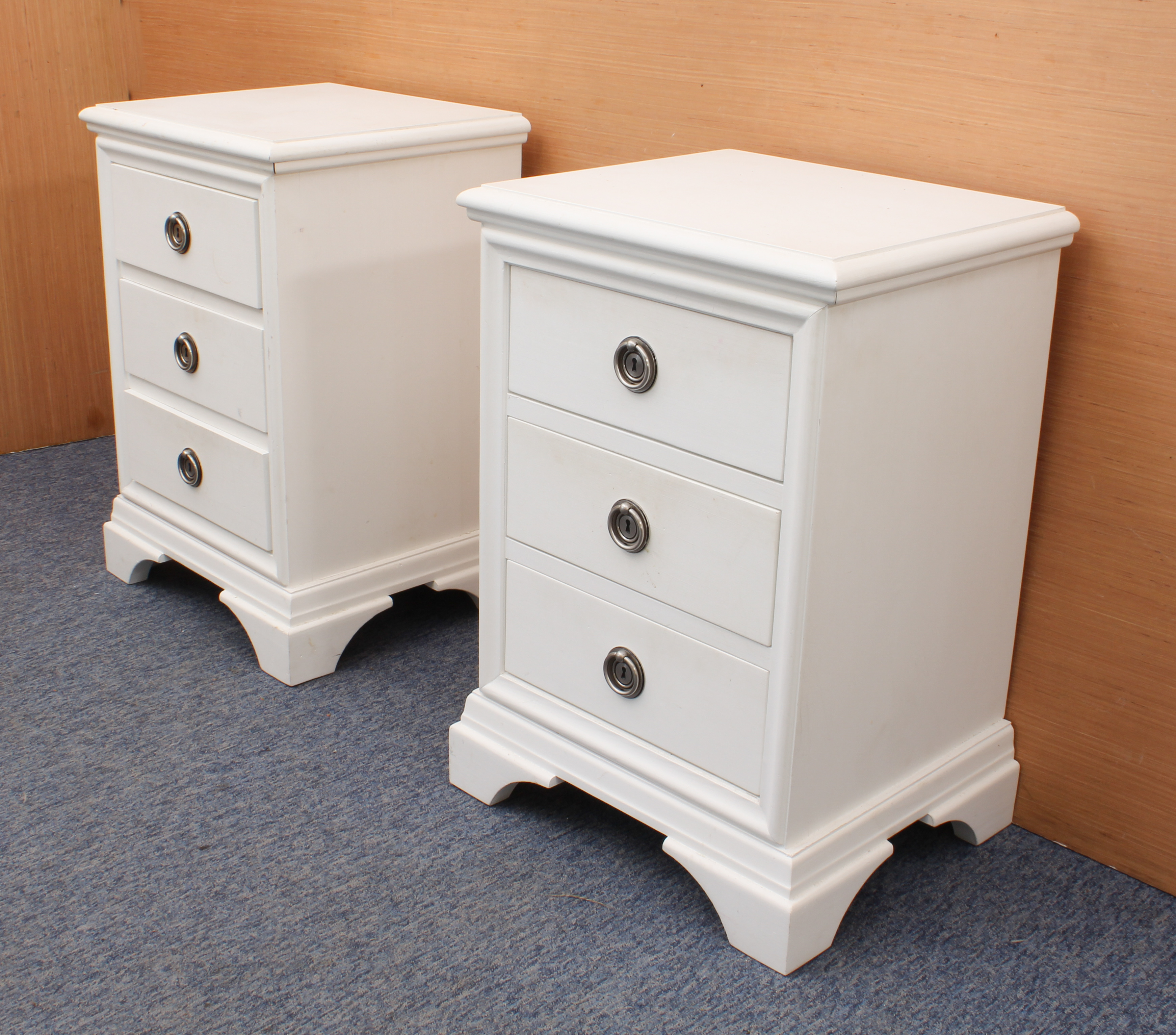 A pair of off-white painted three-drawer bedside cabinets in the 19th century style - modern, with