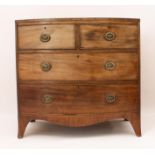 A Regency mahogany bowfronted chest of drawers - the boxwood-strung top over two short and two