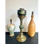 A Victorian brass and pottery oil lamp - the fluted column with foliate capital, to a flared