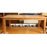 A large modern pine rectangular extending dining table - with pull-out mechanism and two