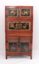 A Chinese red stained pine, lacquered and parcel-gilt three-piece compound cabinet - probably