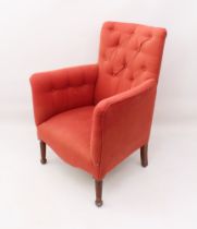 A 19th century style button-back armchair - modern, upholstered in coral pink and raised on