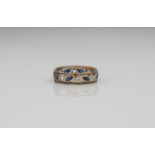 A 9ct gold two-colour sapphire eternity ring - London hallmarks, with alternate round cut white