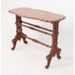 A Victorian figured walnut centre table - the moulded, shaped top raised on pierced, trestle