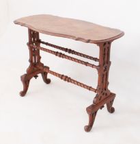 A Victorian figured walnut centre table - the moulded, shaped top raised on pierced, trestle