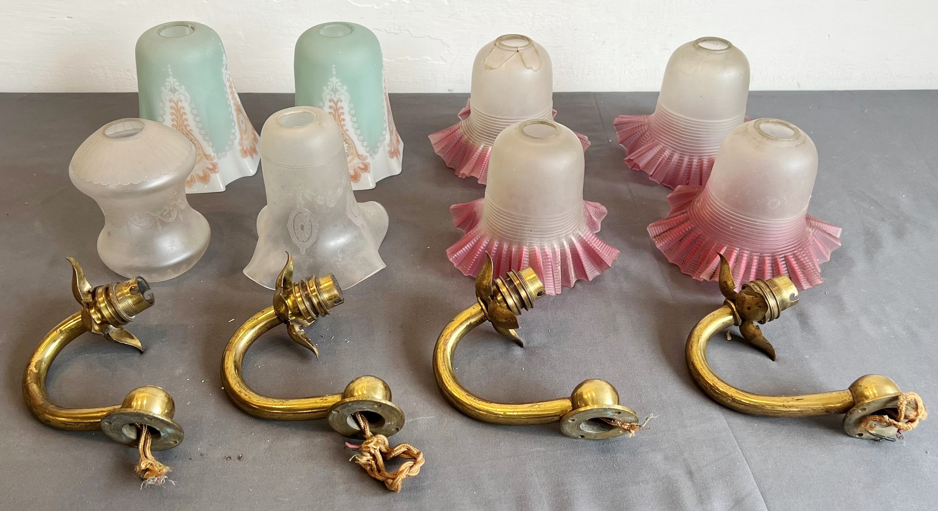 A set of four brass single-arm wall lights - 1920s-30s, of C-scroll form with four-petal floral