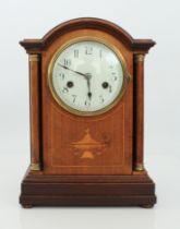 An Edwardian mahogany and marquetry eight-day mantel clock - circa 1910, the arched mahogany case