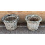 A pair of composite stone garden planters - well weathered, of tapering cylindrical form with