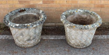 A pair of composite stone garden planters - well weathered, of tapering cylindrical form with