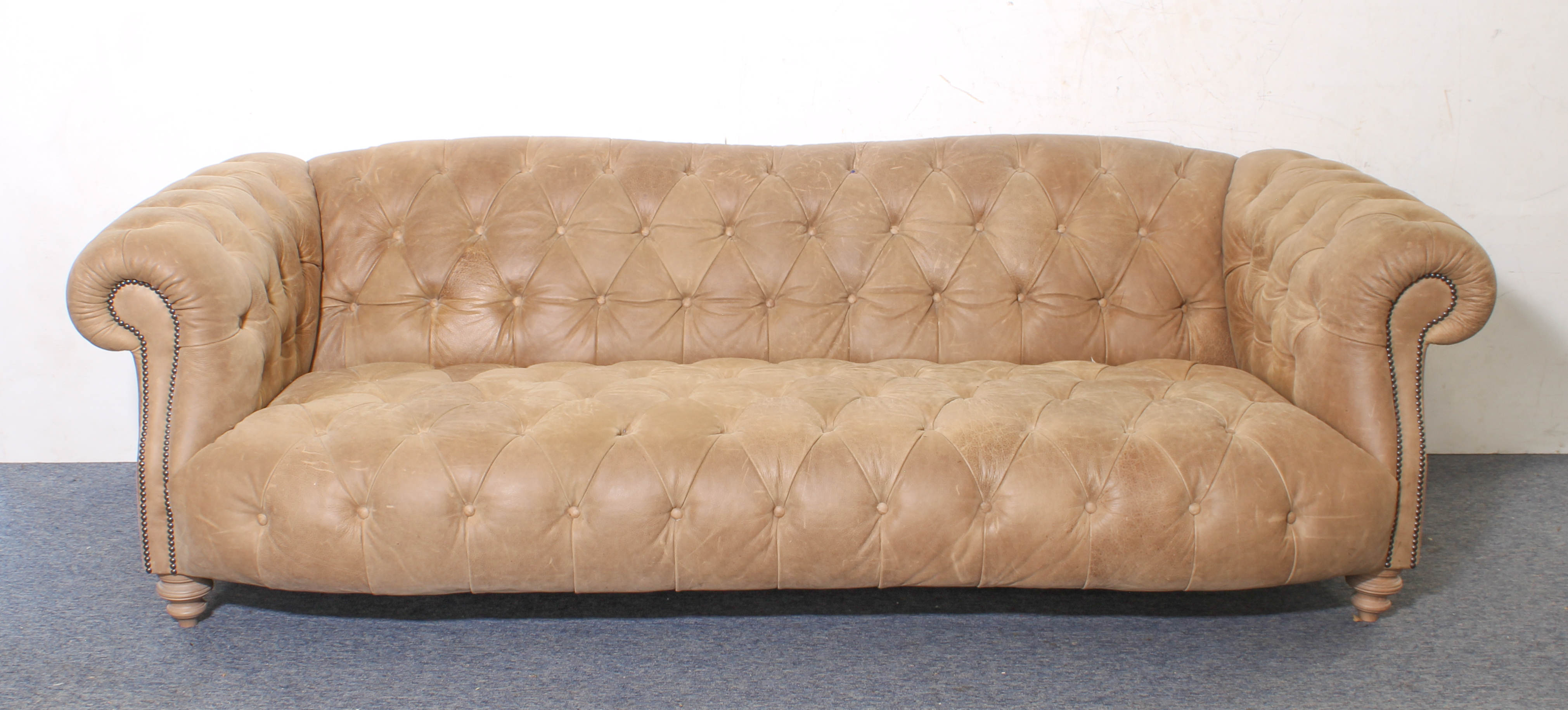 A leather Chesterfield three-seater sofa - modern, in soft pale-brown grained leather, raised on - Image 2 of 4