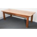 A large Canadian pine farmhouse-style dining table - modern, the distressed, planked top raised on