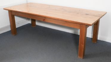 A large Canadian pine farmhouse-style dining table - modern, the distressed, planked top raised on