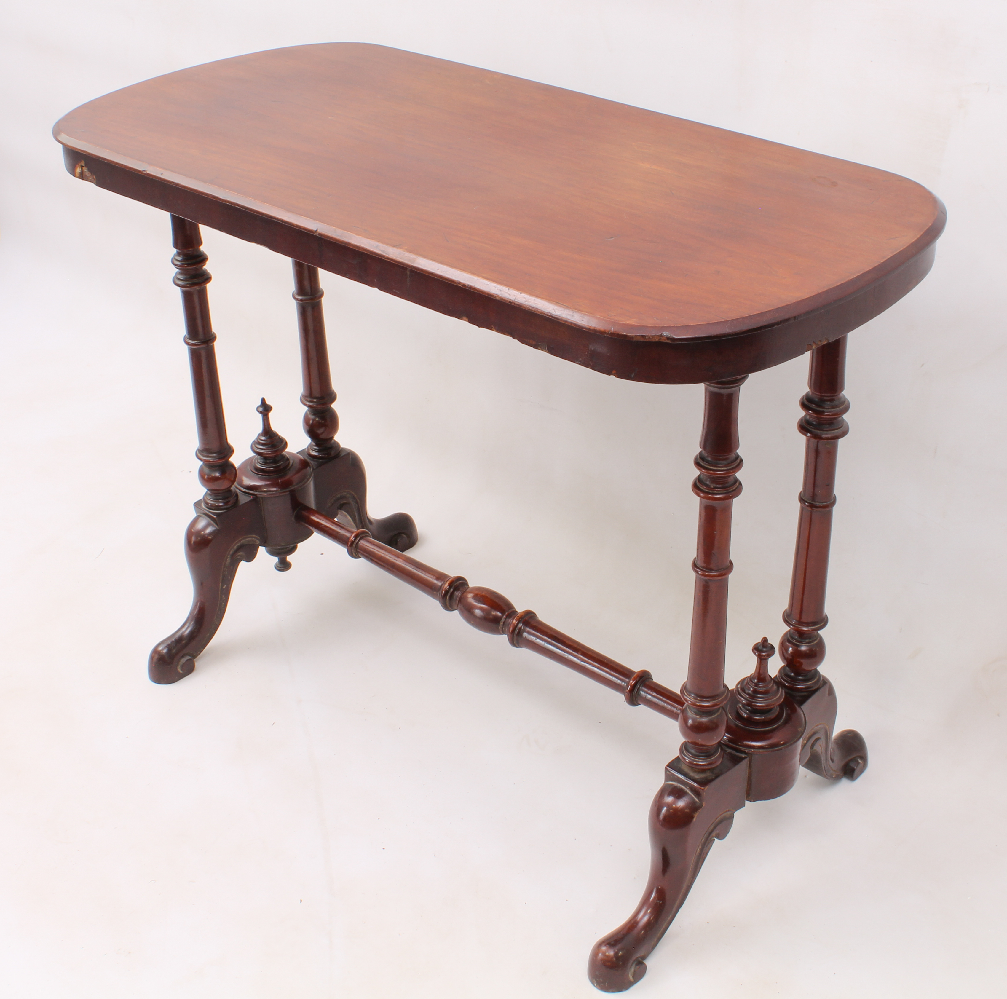 A Victorian mahogany centre table - the rounded, oblong moulded top raised on twin ring-turned