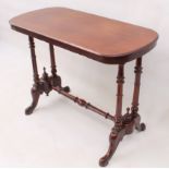 A Victorian mahogany centre table - the rounded, oblong moulded top raised on twin ring-turned