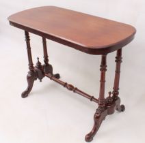 A Victorian mahogany centre table - the rounded, oblong moulded top raised on twin ring-turned