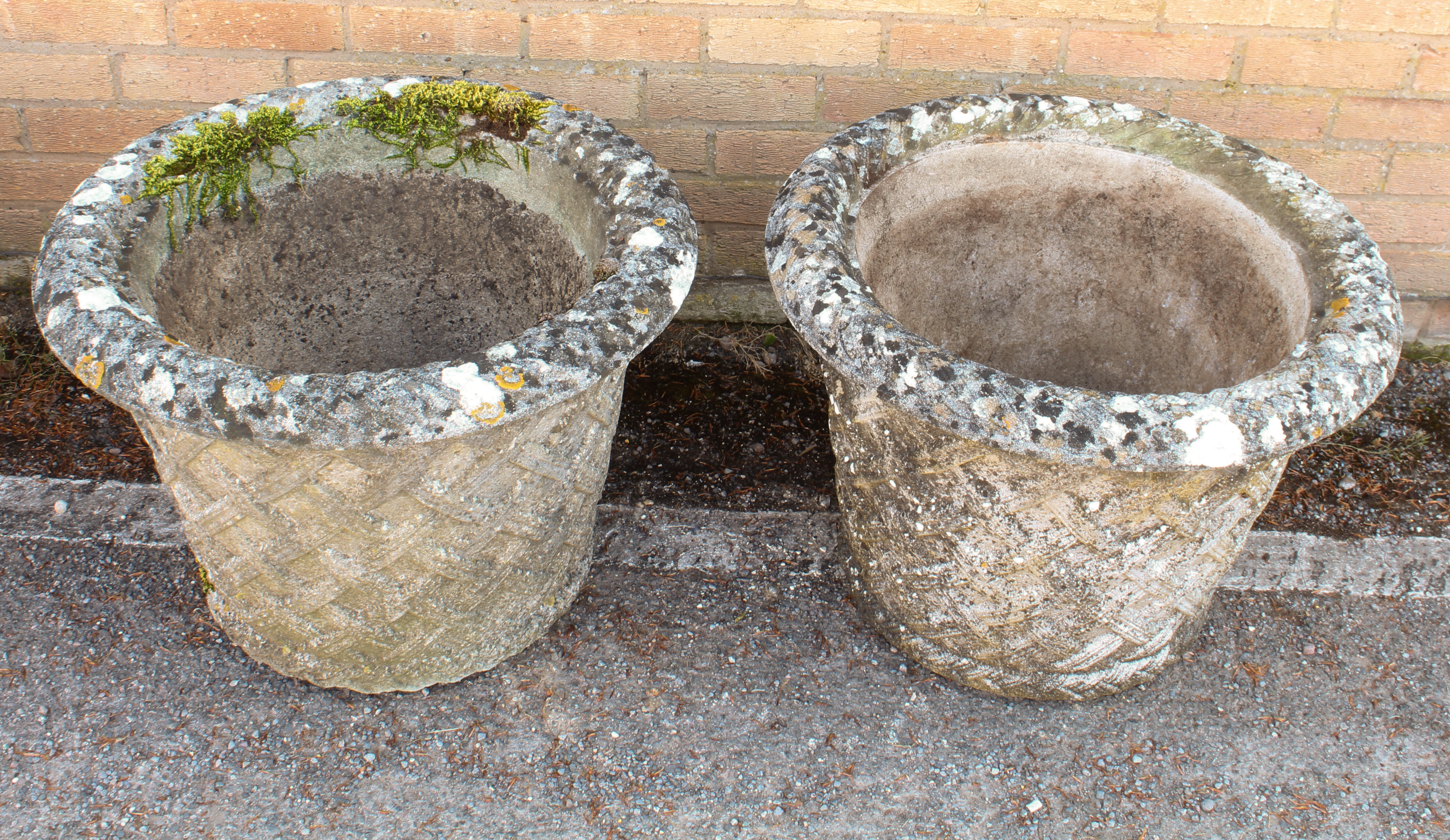 A pair of composite stone garden planters - well weathered, of tapering cylindrical form with