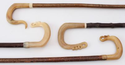 Four carved horn and hazel shepherd's crook walking sticks - three probably Scottish, carved with