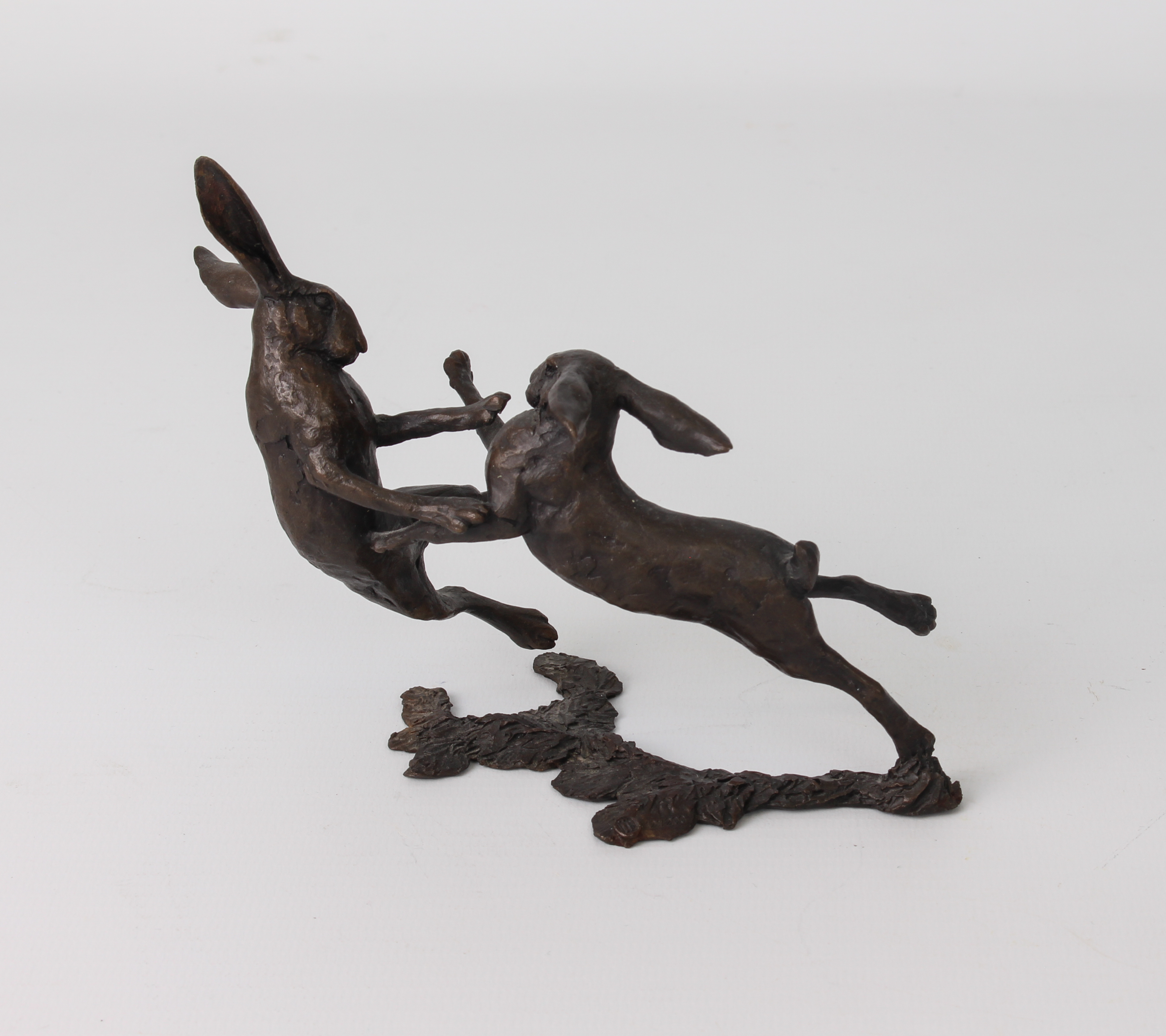 A bronze model of a pair of boxing hares, numbered 121/200, seal mark difficult to read, 11 x 14 cm. - Image 2 of 2