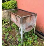 A galvanised metal water trough - with cylinder base, on four legs, 93 x 49cm, 83cm high.