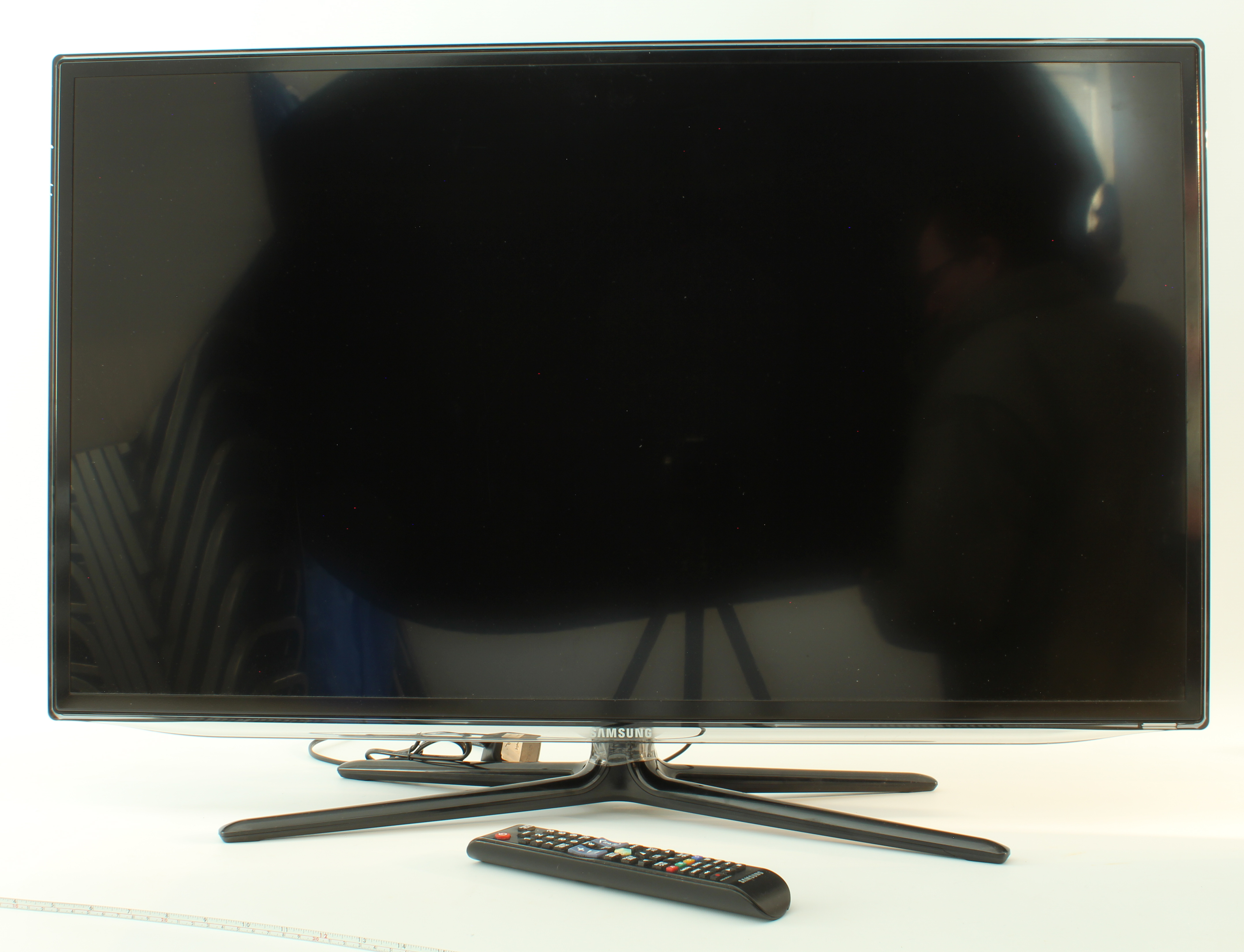 A 37" Samsung tv with remote control and power cable