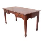 An Edwardian mahogany two-drawer library or writing table - the moulded top over two frieze