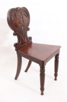 A William IV carved mahogany hall chair - the heart shaped balloon back carved with reeded