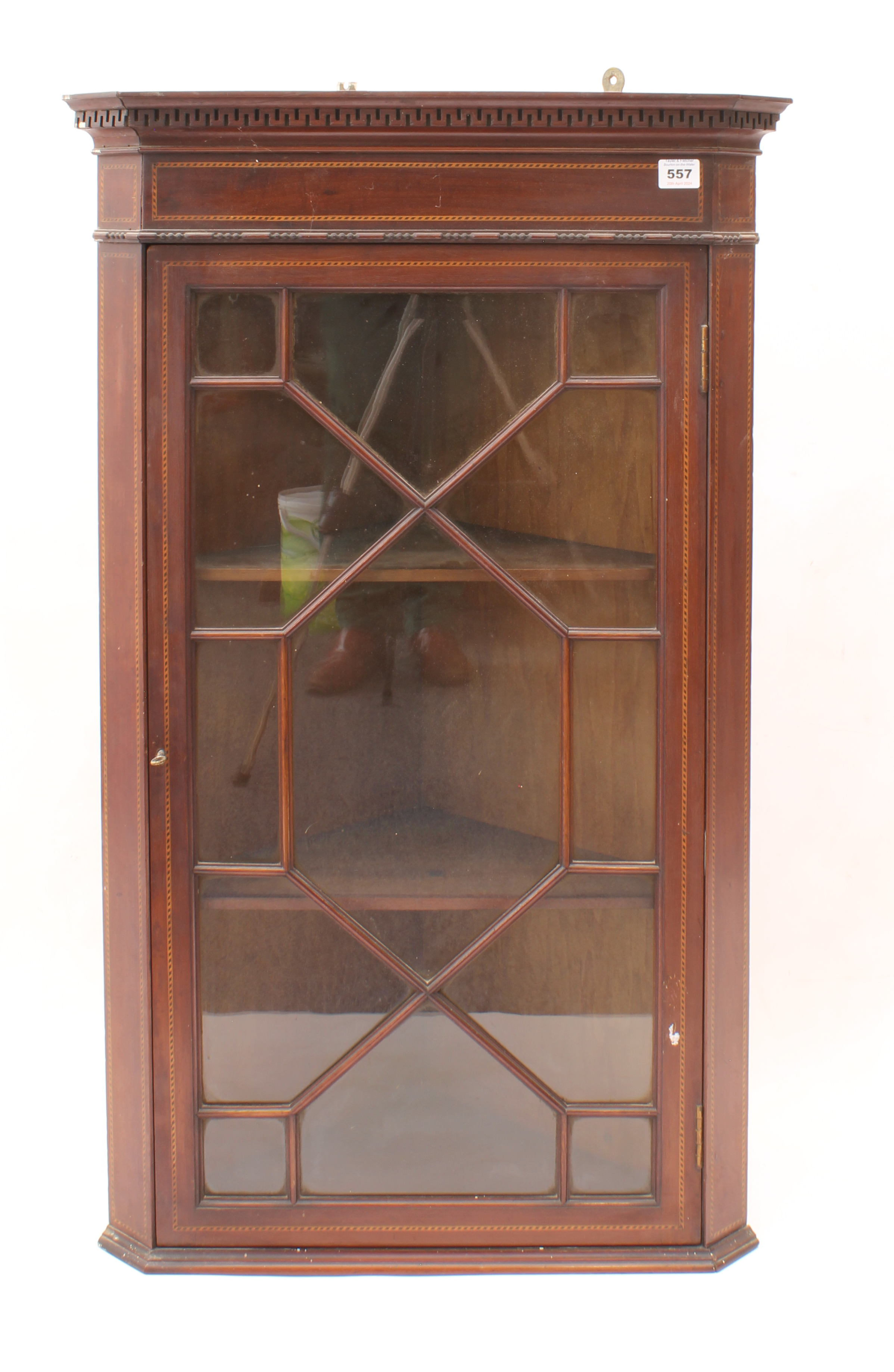 An Edwardian inlaid mahogany corner cupboard